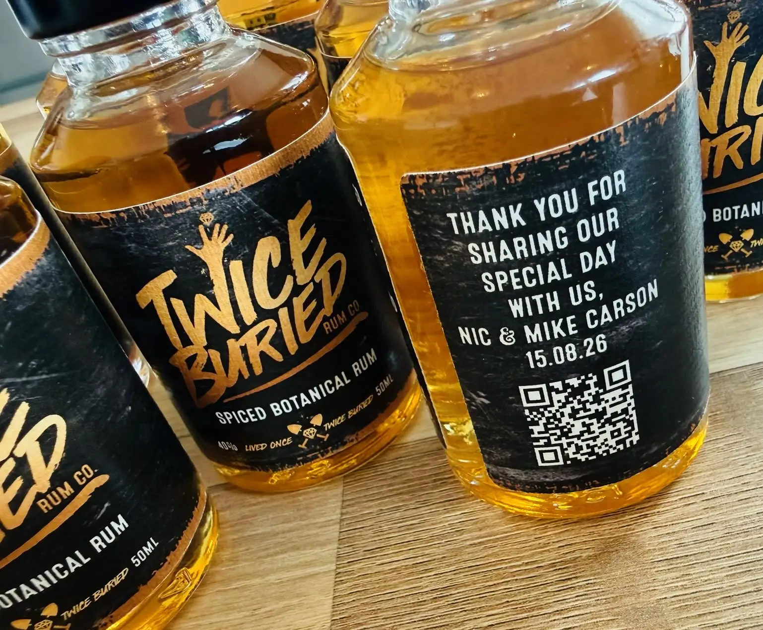 Personalised bottles of Twice Buried Scottish Premium Vodka with thank you labels for the couple's guests